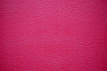 Bright bold pink textured surface.