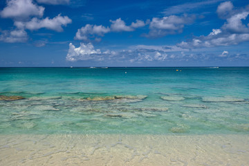Crystal clear waters and pinkish sands on empty seven mile beach on tropical carribean Grand Cayman Island