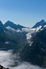 Dombay mountain range in the Caucasus in summer, snow-capped peaks and green mountain slopes