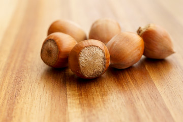 A couple of hazelnuts on a wooden board