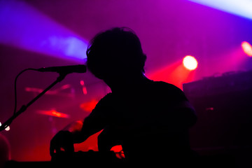 Silhouette of a DJ player in a concert