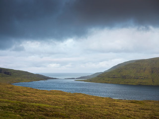 Fototapeta na wymiar dark clouds above lake on Faroe islands Big size