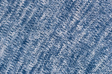 Mottled blue and white woollen sweater. Texture detail close up.