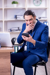 Young handsome businessman working in the office