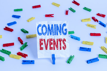 Text sign showing Coming Events. Business photo showcasing Happening soon Forthcoming Planned meet Upcoming In the Future Colored clothespin papers empty reminder white floor background office