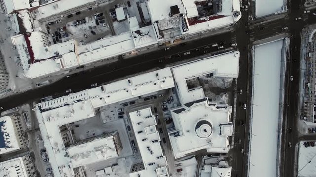 Winter, roads, cars. Snowy roofs and streets of a big Russian city from above. Natural lighting, multicopter shooting.