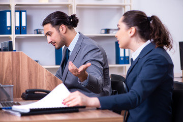 Two employees working in the office