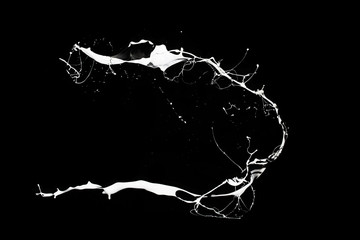 White paint splash isolated on black background.