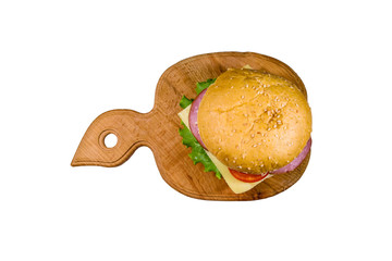 Fresh hamburger on a wooden cutting board isolated on white background