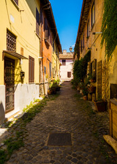 Picturesque street near the Piazza della Rocca (Fortress Square) on the Castle of Julius II. In Ostia Antica, Italy