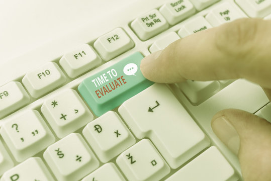 Writing note showing Time To Evaluate. Business concept for judge something with respect to its worth or significance White pc keyboard with note paper above the white background