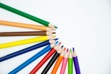 colored pencils on a white background folded in a semicircle