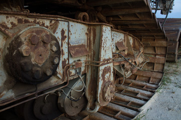 Old rusty tracks of a giant excavator