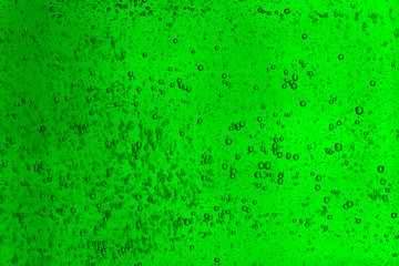 Floating bubbles in green liquid background texture.