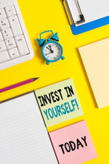 Conceptual hand writing showing Invest In Yourself. Concept meaning nvesting in a coach or a training to learn new things Crumpled white paper on table clock mobile and pc keyboard