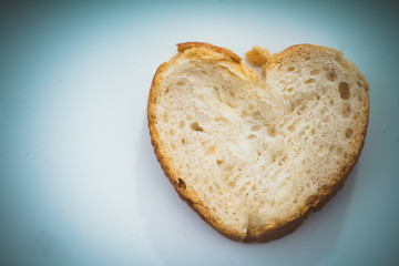heart shaped bread slice on white background