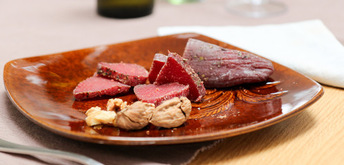Air cured beef served with nuts and red wine