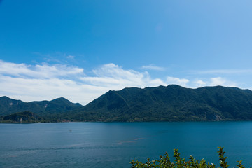 Lago maggiore ore lake maggiore beautiful panorama sunny day with blue sky and fluffy clouds