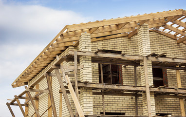 A large yellow brick house is being built
