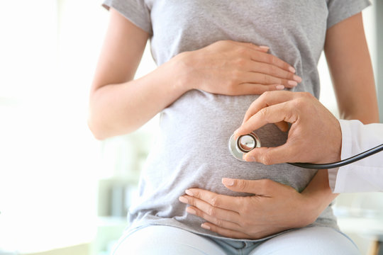 Doctor Examining Pregnant Woman In Clinic