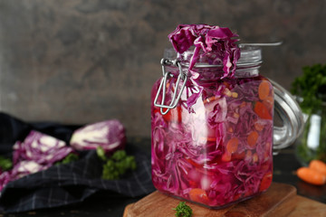 Jar with canned cabbage on table