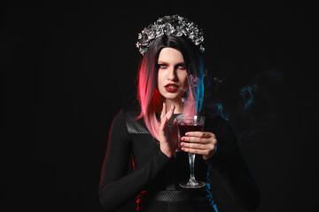 Beautiful woman dressed for Halloween on dark background
