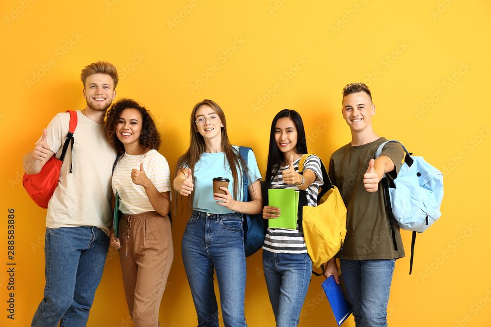 Poster group of students showing thumb-up gesture on color background