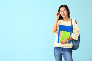 Portrait of Asian student on color background