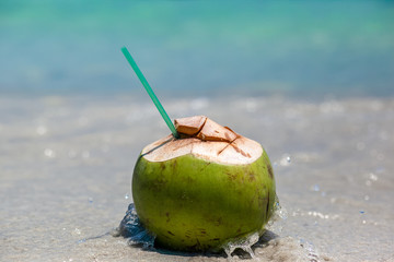 
Coconut lies on the seashore. Paradise Island. 
Tropical cocktail on the beach