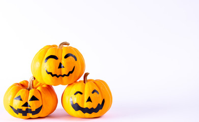 Halloween concept. orange pumpkin jack o lantern decor with funny faces over white background.
