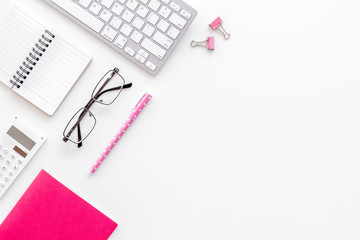 Female work desk with pink supplies on white background flat lay copy space top view top view