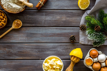 Kitchen frame. Dough ingredients and crockery on dark wooden background top view space for text