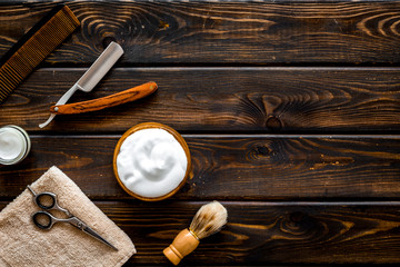 Men's hairdressing tools on dark wooden background top view copy space