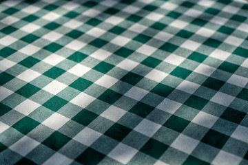 Green checkered table cloth in the garden