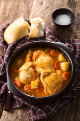 Fresh homemade chicken stew with potato, carrot and celery, seasoned with paprika in rustic bowl (Selective Focus, Focus one third into the image)
