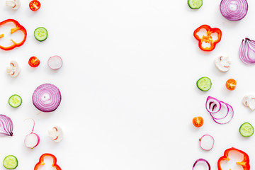 Sliced, cut, chopped vegetables frame on white background top view copyspace