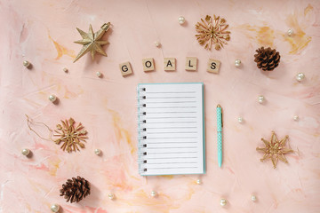 GOALS word and a notepad and pen on a desk