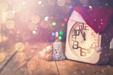 Christmas holiday eve. New year decor with bokeh lights. Magic Winter. Clock at midnight. Greeting new 2020 Year. Clock with blurry magic lights.