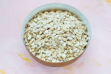 Uncooked oatmeal or oat flakes in a bowl