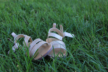 baby sandals on green grass