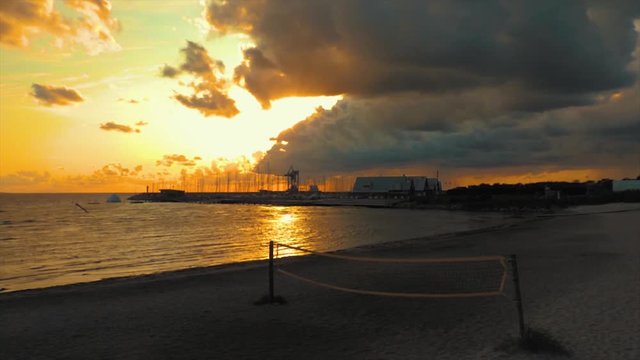 Time-lapse of a sunset over the ocean and a harbor on the coast of Sweden.