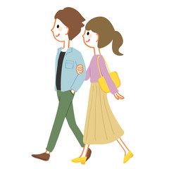 腕を組んで歩く若いカップル　春服