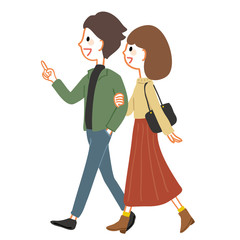 腕を組んで歩く若いカップル　秋服