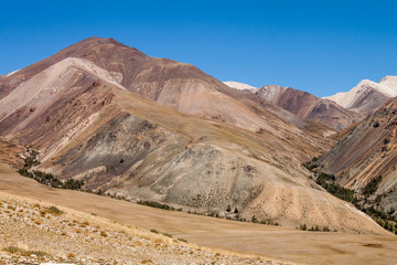 Russia. Altai. Kurai ridge. Multi-colored brown and yellow slopes of the mountains.
