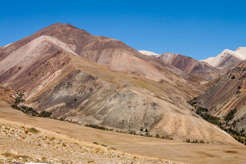 Russia. Altai. Kurai ridge. Multi-colored brown and yellow slopes of the mountains.