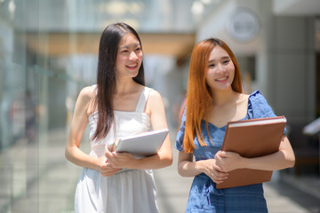 young asian women enjoy walking in building of University after class learning over