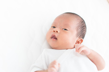 Baby lying on a crib