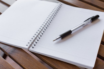 Selective focus of Pen, notebook on the wooden table and copy space