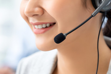 Close up of smiling woman opertor in call center