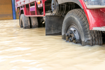 Fototapeta premium Car driving on a flooded road, The broken car is parked in a flooded road. .